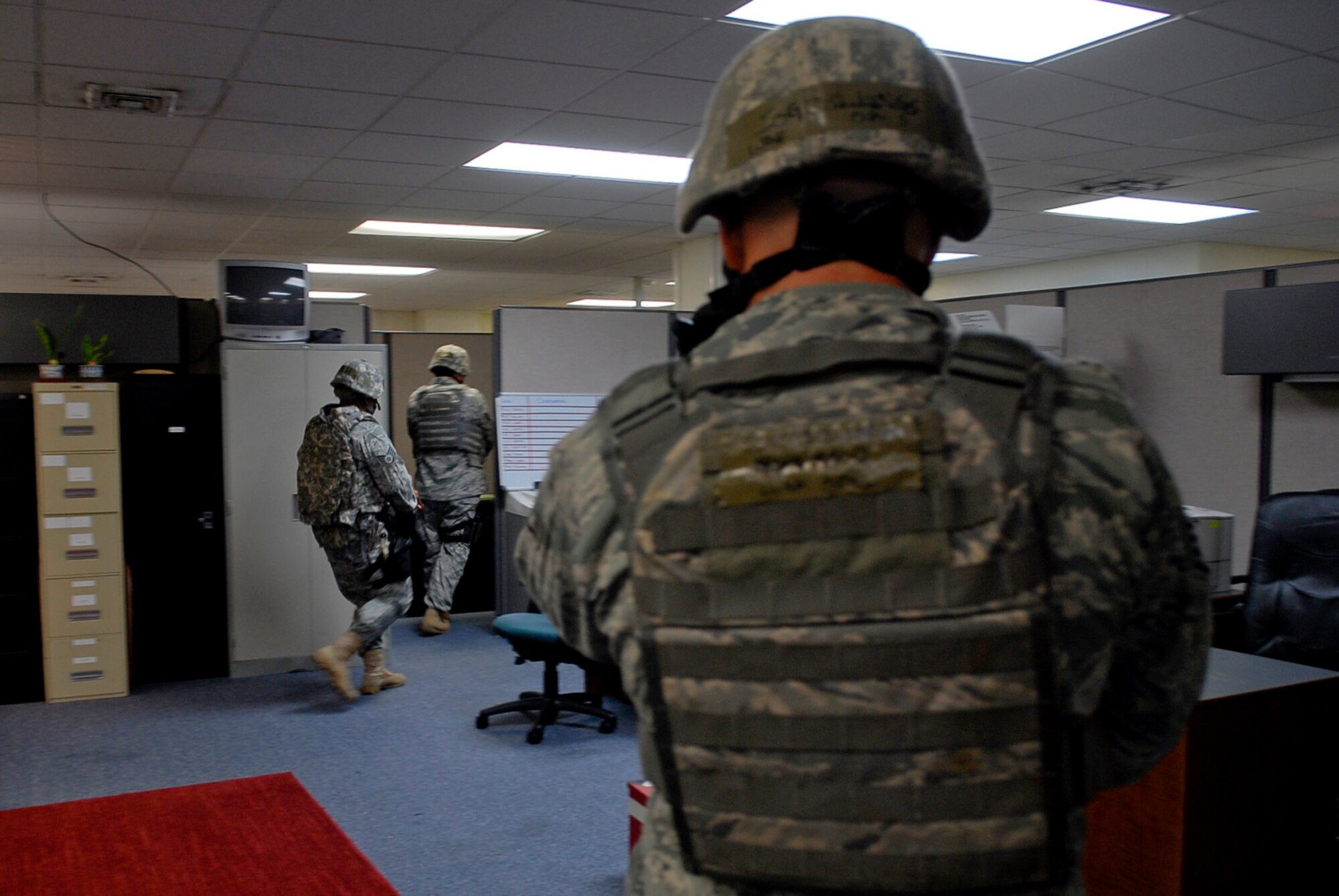 First responders from the 18th Security Forces Squadron conduct a thorough sweep of the building after an active shooter scenario July 13 during Beverly High 11-5, a Local Operational Readiness Exercise at Kadena Air Base, Japan. LORE scenarios gives Kadena's Airmen the chance to participate in training preparing them for real-world contingencies. (U.S. Air Force photo/ Airman 1st Class Tara A. Williamson)