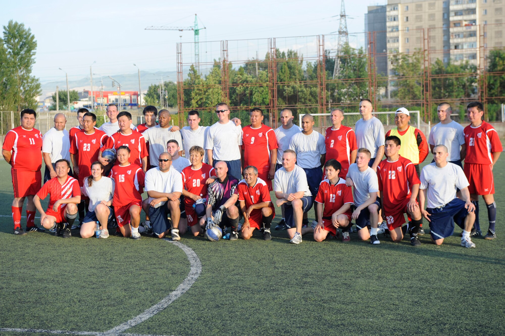 Airmen from the Transit Center at Manas and the Kyrgyz Soccer Federation pose for a photo after a soccer match in Bishkek, Kyrgyzstan, July 9.  Players from the Kyrgyz Soccer Federation staff narrowly defeated the Transit Center team with a 5-4 victory. The game was the fourth match between the two groups -- it was also the fourth victory for the Kyrgyz team. (U.S. Air Force photo/Tech. Sgt. Tammie Moore)