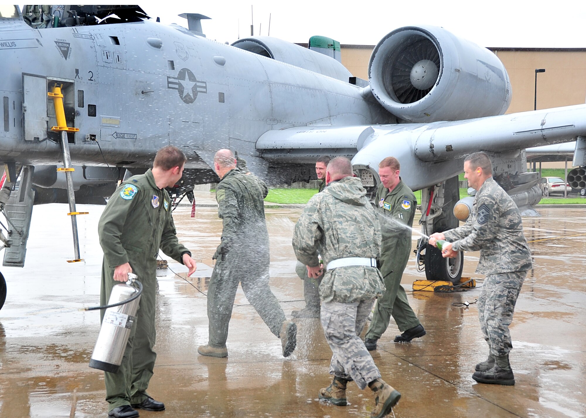 Col. Patrick Malackowski took his final flight as the 51st Fighter Wing commander here July 12.  The 51st Command Chief Master Sergeant and crew members hose down the colonel with champagne and water, to celebrate his final flight.  Colonel Malackowski served as wing commander of the 51st FW since December 2009.  He and his family will depart Osan Air Base, Republic of Korea and head to Hickam Air Force Base, Hawaii, where he will become the 13th Air Force vice commander.  (U.S. Air Force Photos by/Staff Sgt. Daylena Gonzalez)