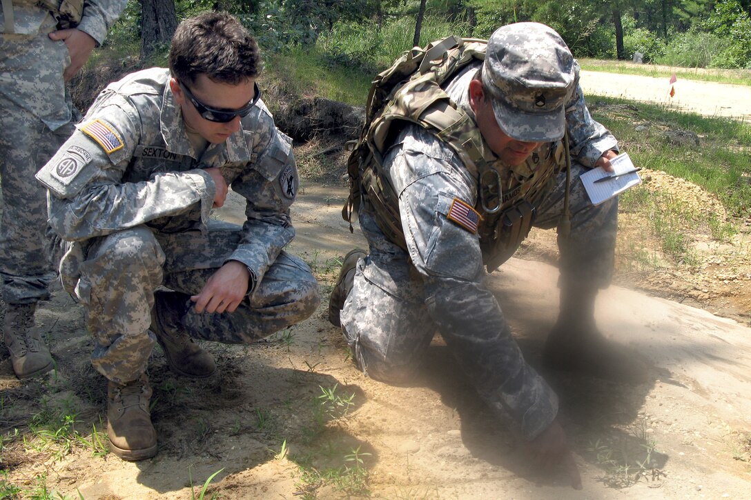Army Staff Sgt. Paul Ramos, right, and Army Sgt. Joseph Sexton, Army reservists with the 425th Civil Affairs Battalion from Encino, Calif., diagram an engagement their civil affairs team is about to conduct during pre-deployment training at Joint Base McGuire-Dix-Lakehurst, N.J., July 7, 2011. DOD photo by Donna Miles