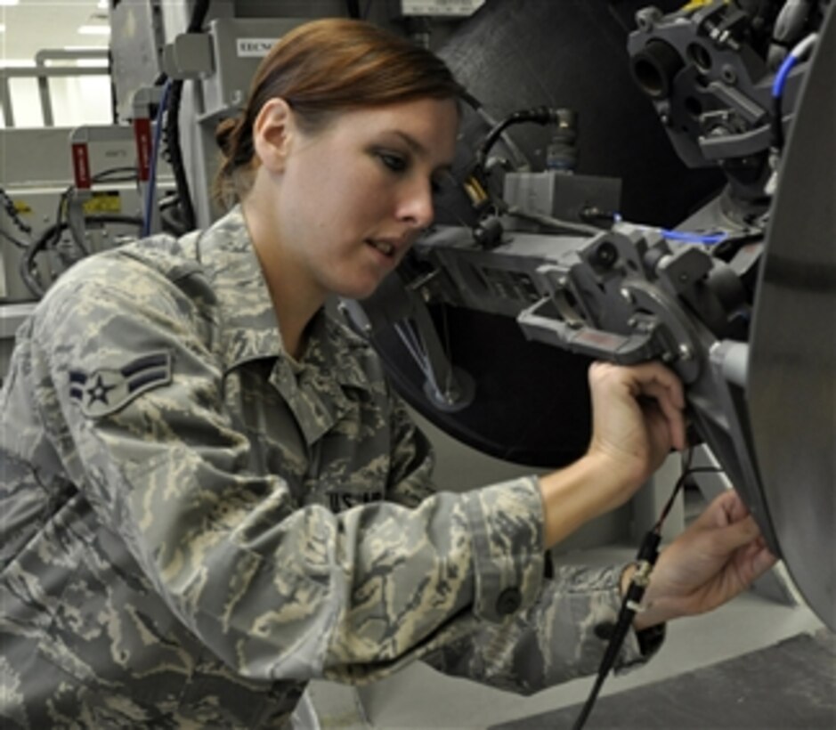 Airman 1st Class Ashley Taylor checks the signals on a satellite receiver/transmitter at Hurlburt Field, Fla., on July 7, 2011.  Taylor is a mission systems journeyman assigned to the 1st Special Operation Component Maintenance Squadron.  