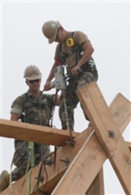 Petty Officer 3rd Class Christopher Baca, assigned to Naval Mobile Construction Battalion 17, uses a heavy timber drill to help construct a 30-foot observation tower at the Construction Battalion Center training facility during Unit Level Training and Readiness Assessment called Operation Sea Hornet in Port Hueneme, Calif., on June 15, 2011.  Operation Sea Hornet provides training ranging from classroom to small unit leadership that will assist in preparing for mobilization to various deployment areas of responsibility.  