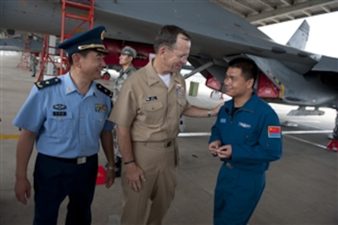 Chairman of the Joint Chiefs of Staff Adm. Mike Mullen thanks a Chinese People's Liberation Army Air Force (PLAAF) airman after a tour of a Sukhoi Su-27 Fighter at the PLAAF 19th Air Division in Shandong, China, on July 12, 2011.  Mullen is on a three-day trip to the country meeting with counterparts and Chinese leaders.  