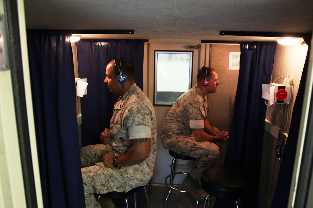 Staff Sgt. Wilfredo Segovia-Aguilar (left), 34,::r::::n::from Elizabeth, N.J., program manager, and::r::::n::Staff Sgt. Charles Mitchell (right), 34, from::r::::n::Carlsbad, Calif., Edson Range’s post exchange::r::::n::manager, both with Service Company, Combat::r::::n::Logistics Regiment 17, 1st Marine Logistics::r::::n::Group, take the annual audiogram test on::r::::n::Camp Pendleton, Calif., July 13.