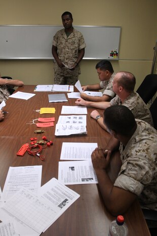 Petty Officer 2nd Class Jason Smith, Navy cryogenics machinist mate, gives a Lockout/Tagout class at the Navy Cryogenics facility here July 13. The Lockout/Tagout program is a documented process used to monitor potentially hazardous valves and systems by either physically locking the system or placing descriptive caution or danger tags on the equipment. The Navy Cryogenics team are the first to receive training before giving their input to station safety.
