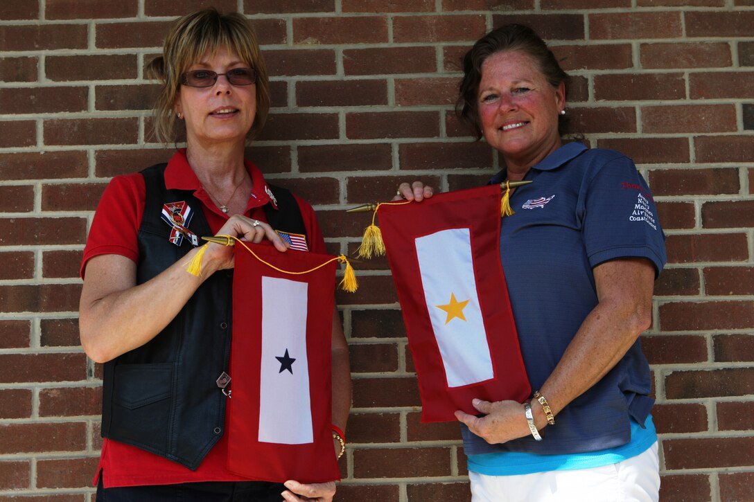 Colleen Greene (left) and Deb Tanish stand with their respective blue and gold star flags; the blue symbolizing that they either have a son or daughter in the armed forces and the gold meaning a son or daughter who has died while in the service. Following her son’s death in 2004, Tanish has made it her mission to spread the stars meaning and the knowledge of various support groups for blue and gold star parents who do not realize the support system available to them.