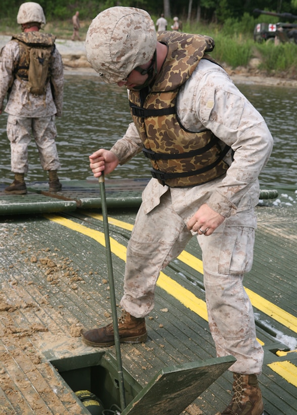 110714-M-0381W-001: MARINE CORPS BASE CAMP LEJEUNE, N.C. – Sgt. Joshua L. Currie, a combat engineer with 8th Egineer Support Battalion, 2nd Marine Logistics Group, uses a hydraulic pump to guide the ramp of an Improved Float Bridge during an operation aboard Marine Corps Base Camp Lejeune July 14, 2011. The objective of the mission was to ferry 10 M1A1 Abrams Main Battle Tanks and one M88 Hercules Heavy Equipment Recovery Vehicle to the annual gunnery qualifications for 2nd Tank Battalion, 2nd Marine Division. (Marine Corps Photo by Pvt. Brian M. Woodruff)