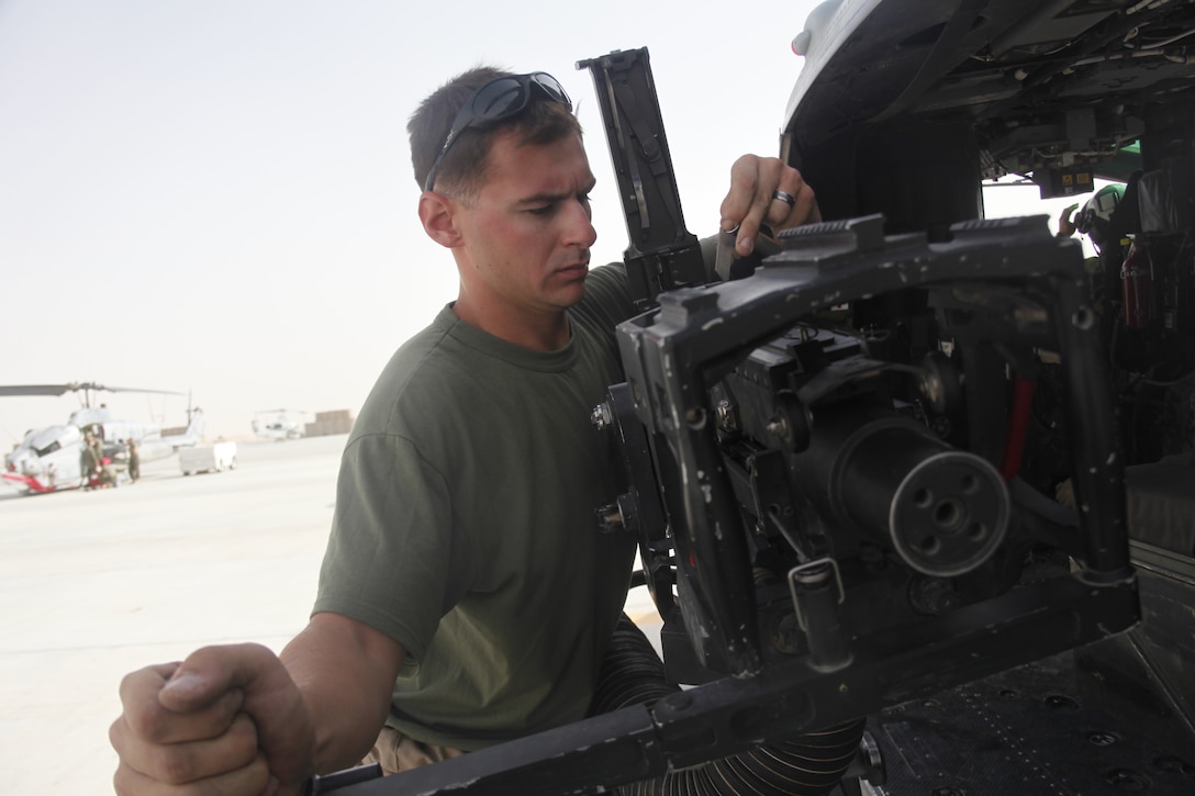 Sgt. Andrew W. Morey readies a .50-caliber machine gun on a UH-1Y Huey at Camp Bastion, Afghanistan, July 16. 2nd Marine Aircraft Wing (Forward) moved a detachment of helicopters from Marine Light Attack Helicopter Squadron 267 to Forward Operating Base Edinburgh so that air ambulances and the attack helicopters that support them could be at the same place, at the same time, when they’re needed most. Morey is a native of Somers, N.Y. and a Huey crew chief with HMLA-267.