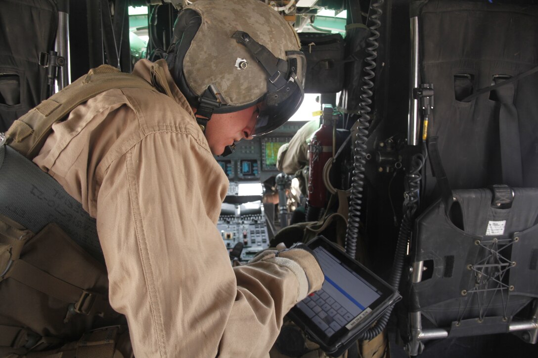 Sgt. Andrew W. Morey looks up grid coordinates on an Apple iPad during a troop in contact mission supporting Forward Operating Base Edinburgh, Afghanistan, July 16. Morey is a native of Somers, N.Y. and a Huey crew chief with Marine Light Attack Helicopter Squadron 267.