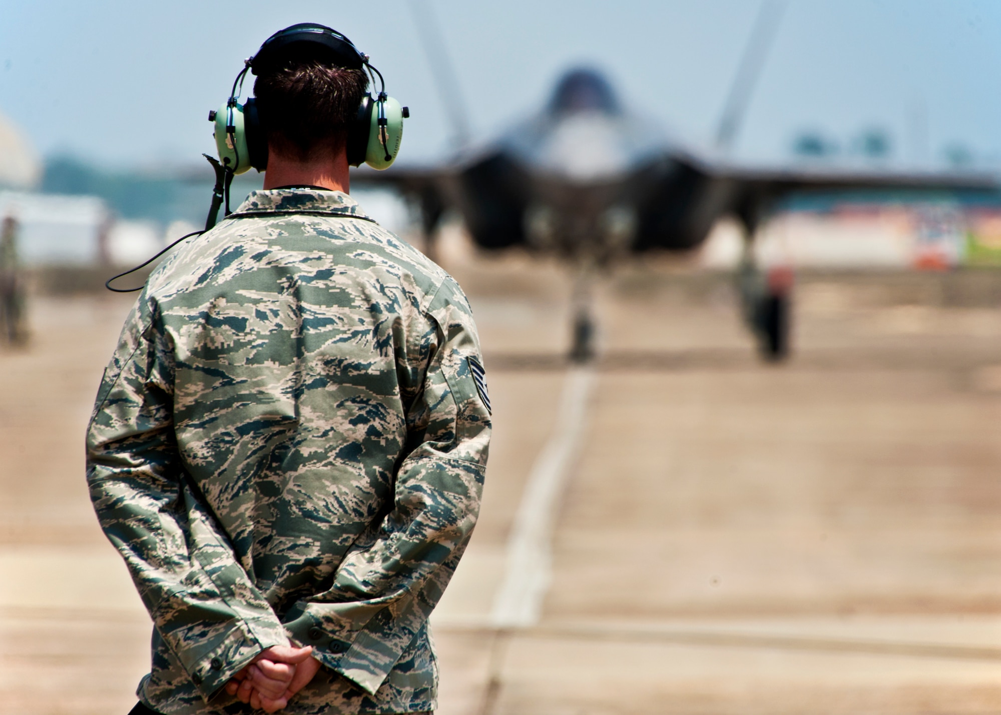 F-35 Lightning II joint strike fighter crew chief, Tech. Sgt. Brian West, watches his aircraft approach for the first time at Eglin Air Force Base, Fla., July 14.  Aircraft 0747 is DoD’s newest aircraft.  (U.S. Air Force photo/Samuel King Jr.)