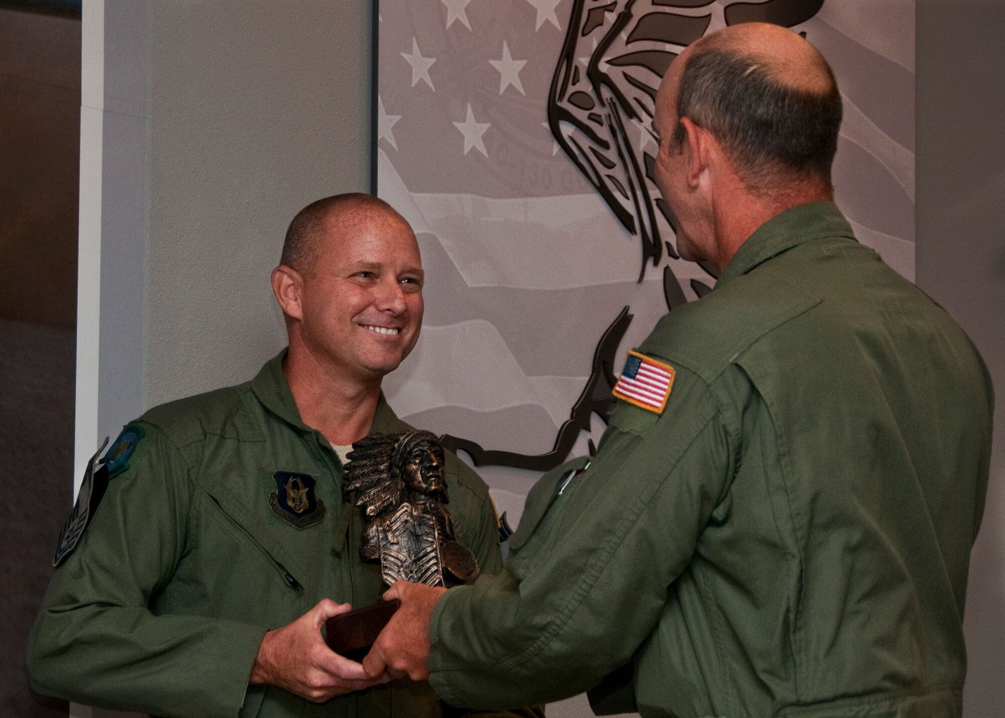 Chief Master Sgt. Thomas Mason, of the 711th Special Operations Squadron, receives the Chief's bust during his chief induction ceremony at Duke Field July 9.  (U.S. Air Force photo/Tech. Sgt. Samuel King Jr.)

