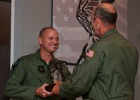 Chief Master Sgt. Thomas Mason, of the 711th Special Operations Squadron, receives the Chief's bust during his chief induction ceremony at Duke Field July 9.  (U.S. Air Force photo/Tech. Sgt. Samuel King Jr.)
