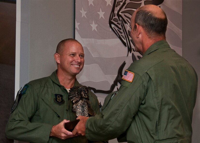 Chief Master Sgt. Thomas Mason, of the 711th Special Operations Squadron, receives the Chief's bust during his chief induction ceremony at Duke Field July 9.  (U.S. Air Force photo/Tech. Sgt. Samuel King Jr.)
