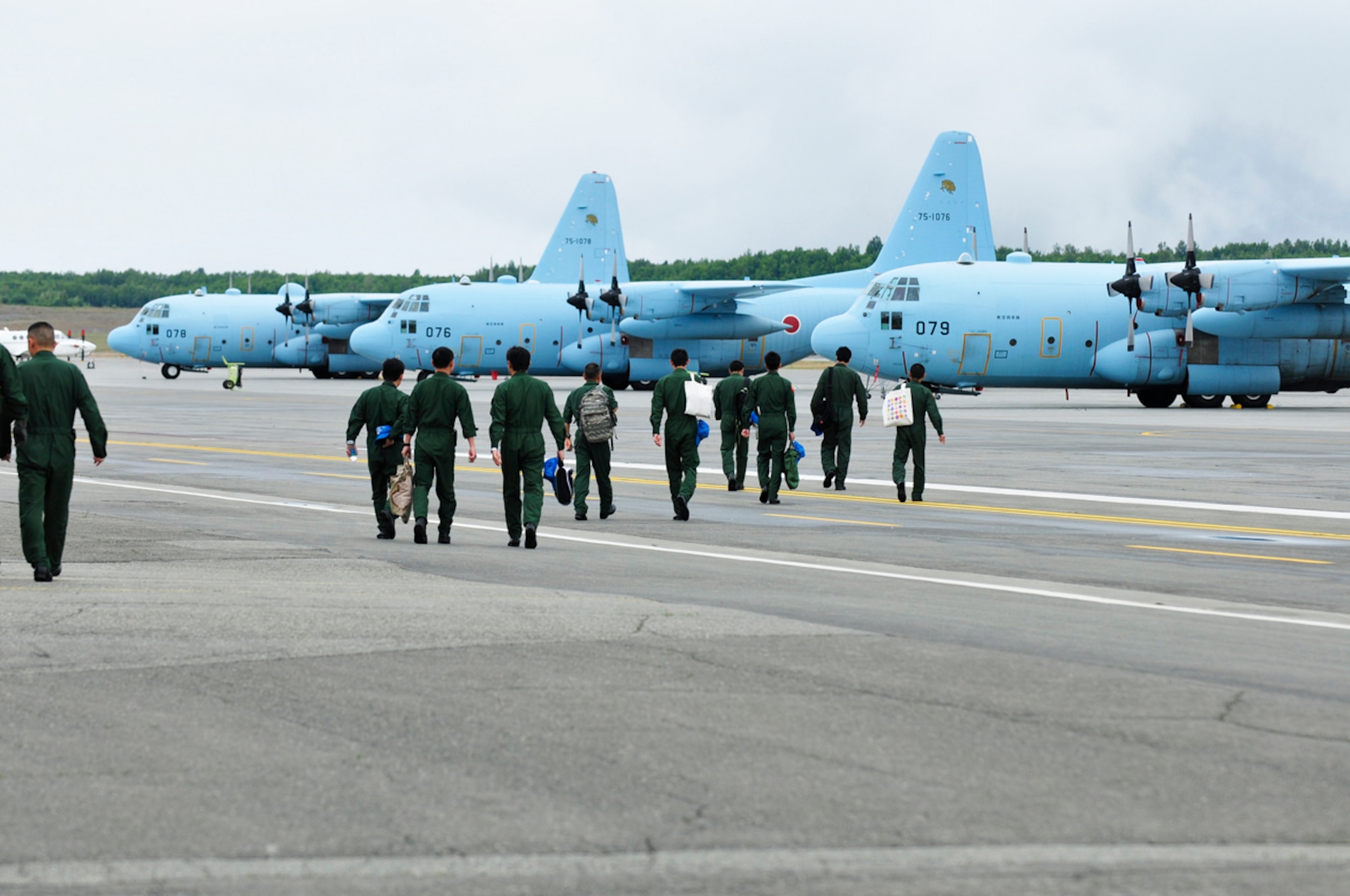 JOINT BASE ELMENDORF-RICHARDSON, Alaska -- Japanese Air Self-Defense Force C-130 Hercules crews walk to their aircraft in preparation for another day of flights in support of the multinational training exercise, Red Flag 11-2, hosted at Joint Base Elmendorf-Richardson and Eielson Air Force Base. The exercise concludes July 22. (U.S. Air Force photo/Steve White)