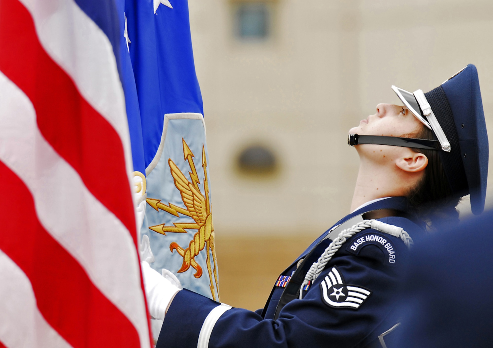 JOINT BASE ELMENDORF-RICHARDSON, Alaska -- U.S. Air Force Staff Sgt. Jiney Parton of Tampa, Fla., adjusts a flag prior to the change of command ceremony for the 673d Medical Group, Friday, July 8, 2011.  U.S. Air Force Col. Paul Friedrichs turned over command of the group to Col. Thomas Harrell as Col. Robert Evans officiated before gathered family members, distinguished guests and military officers and enlisted personnel.  (U.S. Air Force photo/Justin Connaher)