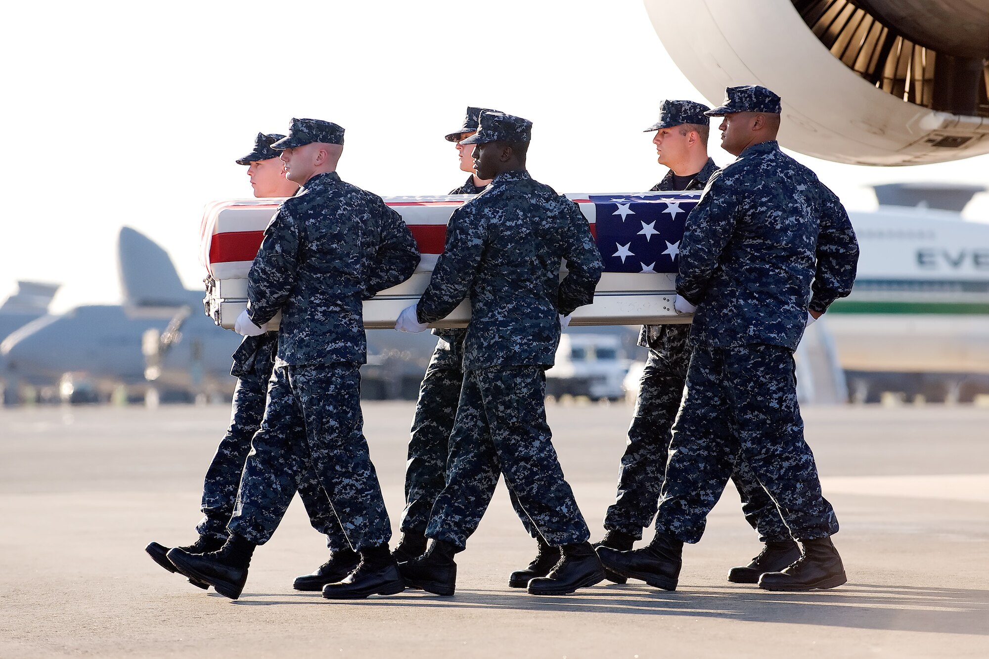 A U.S. Navy carry team transfers the remains of Navy Seaman Aaron D. Ullom, of Midland, Mich., at Dover Air Force Base, Del., July 14, 2011. Ullom was assigned as a hospitalman to 3rd Battalion, 2nd Marine Regiment, Regimental Combat Team 8, 2nd Marine Division, II Marine Expeditionary Force, Camp Lejeune, N.C. (U.S. Air Force photo/Steve Kotecki)