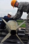 KUNSAN AIR BASE, Republic of Korea -- Airman Aaron Fierros and Airman 1st Class Stephen Whitemore, 8th Maintenance Squadron conventional maintenance crew members, cross load inert munitions from trailer to trailer to prepare frags for Kunsan and theater support package aircraft here July 13 for the upcoming Operational Readiness Exercise. The exercise is conducted to ensure members of the Wolf Pack remain ready to execute its mission of ?Defend the Base, Accept Follow on Forces and Take the Fight North.? (U.S. Air Force photo/Senior Airman Brittany Y. Bateman)