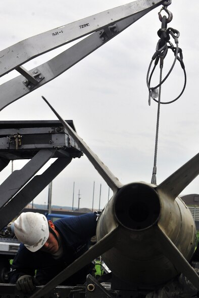KUNSAN AIR BASE, Republic of Korea -- Airman Aaron Fierros, 8th Maintenance Squadron conventional maintenance crew member, unloads an inert munition on a trailer to prepare frags for Kunsan and theater support package aircraft here July 13 for the upcoming Operational Readiness Exercise. Ammo is a diverse career field. Ammo Airmen can build bombs for just about any airframe in just about any deployed environment. But when they're at one base, they may focus on just one aircraft. (U.S. Air Force photo/Senior Airman Brittany Y. Bateman)

