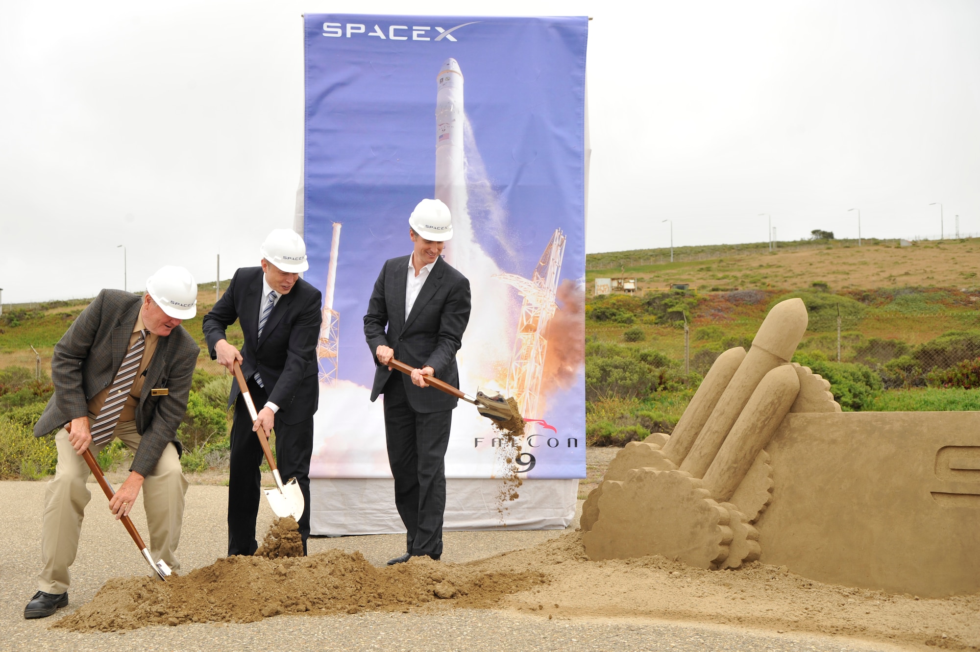 VANDENBERG AIR FORCE BASE, Calif. -- Lompoc Mayor John Linn, Elon Musk, the founder and chief executive officer of SpaceX, and California Lt. Govenor Gavin Newsom, shovel sand during the ground breaking ceremony at Space Launch Complex 4 East here Wednesday, July 14, 2011.  SpaceX has plans to launch their Falcon Heavy from Vandenberg in 2013.  (U.S. Air Force photo/Staff Sgt. Andrew Satran) 

 