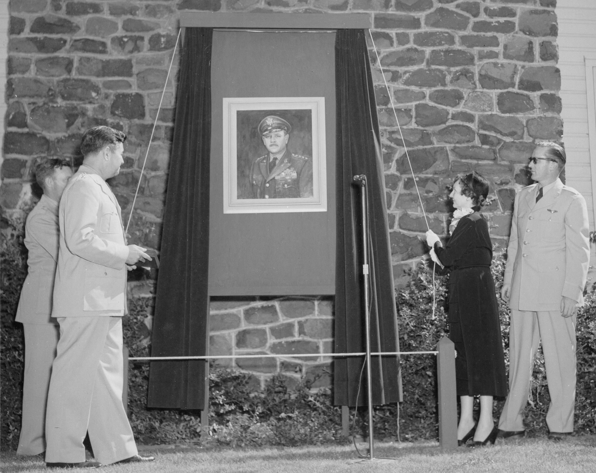 Gen. C. J. Bondley Jr., 57th Air Division Commander,  Lt. Gen. Curtis E. LeMay,  Mrs. Fairchild, Lt. McGanoy, Assistant Club Officer unveil a portrait of Gen. Muir S. Fairchild, Vice Chief of Staff of the Air Force. Fairchild Air Force Base was named after Gen. Fairchild. (Historical photo)