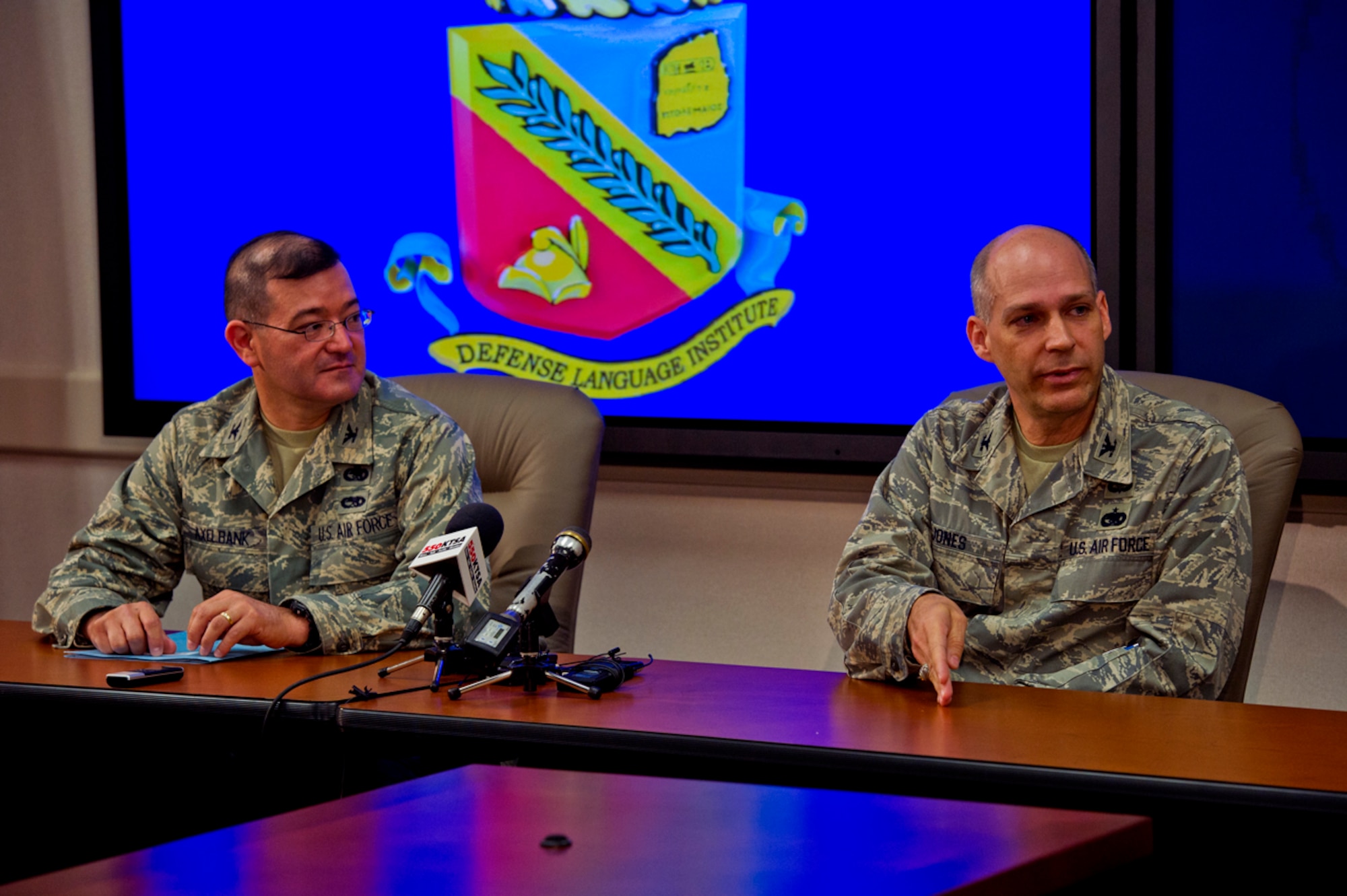 Col. Eric Axelbank (left), commander of the 37th Training Wing, and Col. Howard D. Jones III, commandant of the Defense Language Institute English Language Center, participate in a press conference held July 13, 2011, at Lackland Air Force Base, Texas, for four Afghan Army pilot candidates. (U.S. Air Force photo/Senior Airman Marleah Miller)