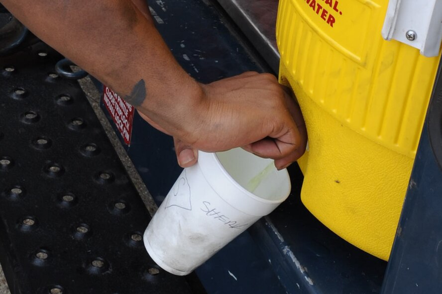 Airman 1st Class Deven Sherk, 2nd Maintenance Squadron, fills a cup with a sports drink on Barksdale Air Force Base, La., July 14. During the summer months, Barksdale's temperature highs average approximately 92 degrees Fahrenheit, which makes staying hydrated vital when working outside. (U.S. Air Force photo/Airman 1st Class Micaiah Anthony)(RELEASED)