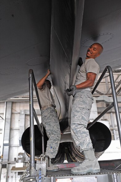 Airman 1st Class Deven Sherk, 2nd Maintenance Squadron, holds a trailing edge power pod fairing while Airman 1st Class Justen Laganse, 2 MXS, ensures the fairing is in-line with the B-52H Stratofortress in a hangar on Barksdale Air Force Base, La., July 14. The fairing protects the engine-strut and fuel lines while improving the aerodynamics of the B-52. (U.S. Air Force photo/Airman 1st Class Micaiah Anthony)(RELEASED) 