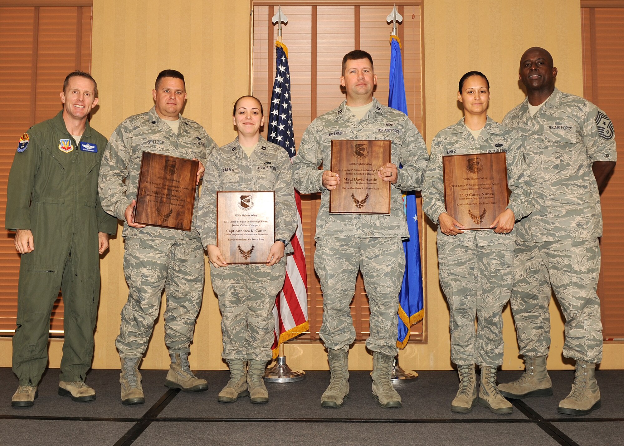 U.S. Air Force Col. John Cherrey, 355th Fighter Wing commander, and Chief Master Sgt. Vincent Howard, 355th Fighter Wing command chief, stand with award winners at the Lance P. Sijan Leadership Awards breakfast held at Davis-Monthan Air Force Base, Ariz. The Lance P. Sijan Leadership Award was created in 1981 to recognize individuals who have demonstrated the highest qualities of leadership in their jobs and in their lives. (U.S. Air Force photo by Senior Airman Brittany Dowdle)