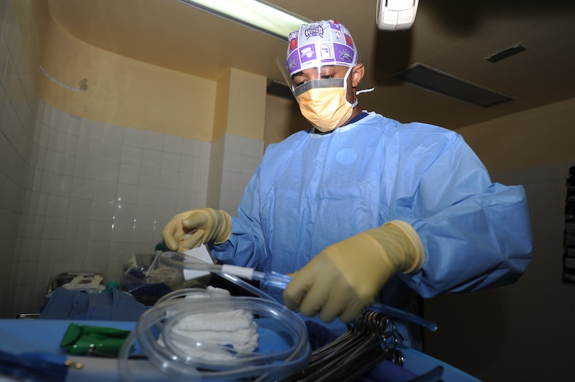 Senior Airman Terrell Powell, JTF-Bravo Medical Element operating room technician, prepares suction tubing before a surgery July 12, 2011 at a community hospital in Comayagua, Honduras. Airman Powell is part of a five person Joint Mobil Surgical Team who completed three surgeries on Honduran nationals on that day. (U.S. Air Force photo/Tech. Sgt. Matthew McGovern)