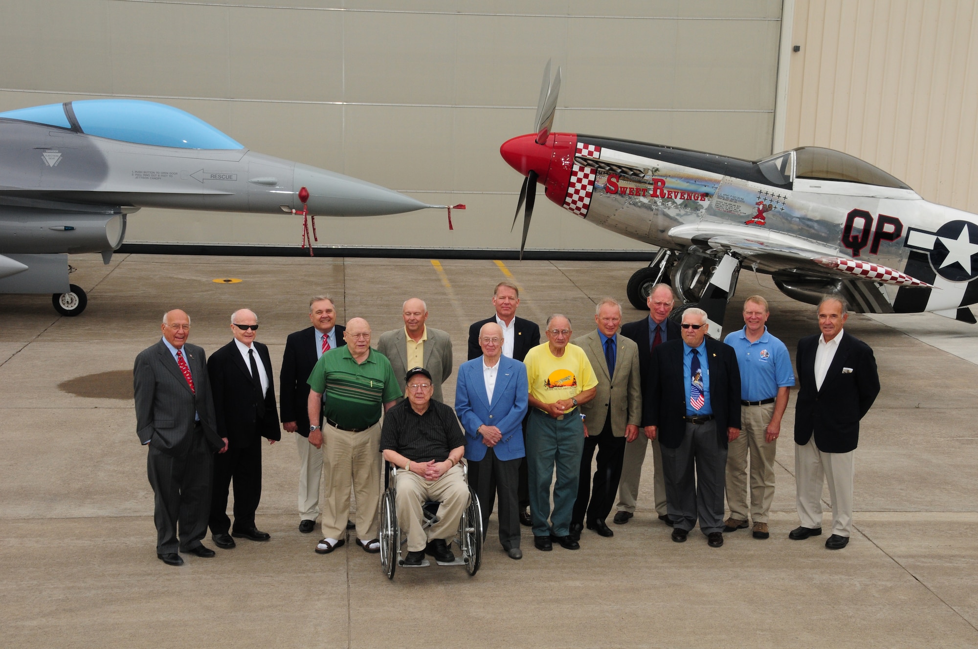 Former 148th Fighter Wing members along with other special guests pose for a group shot with the P-51 Mustang and the block 10, F-16 during the Minnesota Air National Guard's 90th Anniversary celebration. The P-51 Mustang is the original aircraft flown by the 148th Fighter Wing and was flown from 1948 to 1954.   (U.S. Air Force photo by Master Sgt. Ralph Kapustka/released)