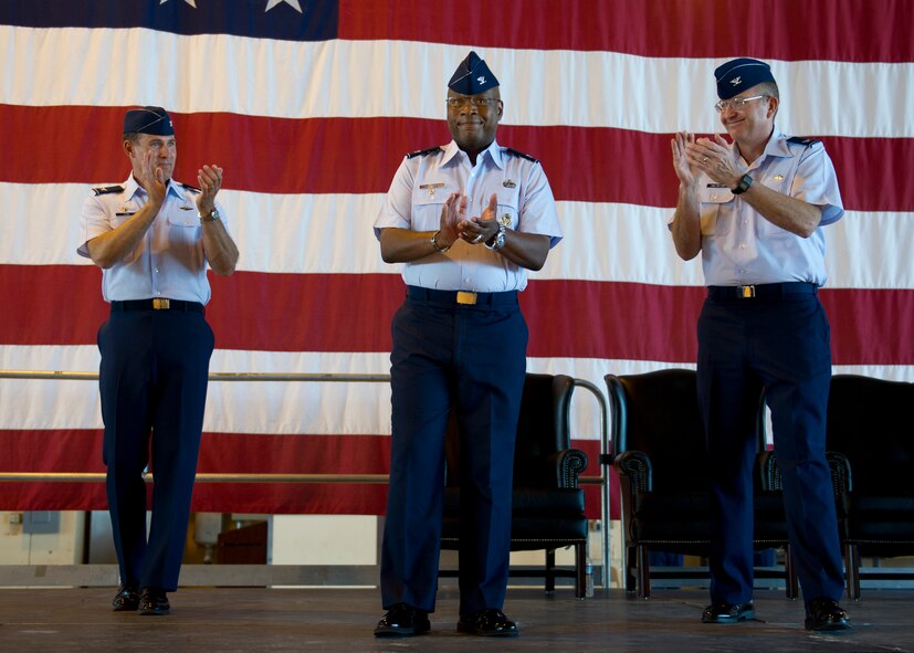 HOLLOMAN AIR FORCE BASE, N.M. -- Col. André Kennedy, 49th Maintenance Group commander, receives applause from Col. David Krumm, 49th Wing commander, and Col. Donald Van Patten, former 49th MXG commander, during the 49th MXG Change of Command ceremony July 11, 2011, in Hangar 301. (U.S. Air Force photo by Senior Airman John D. Strong II/Released)
