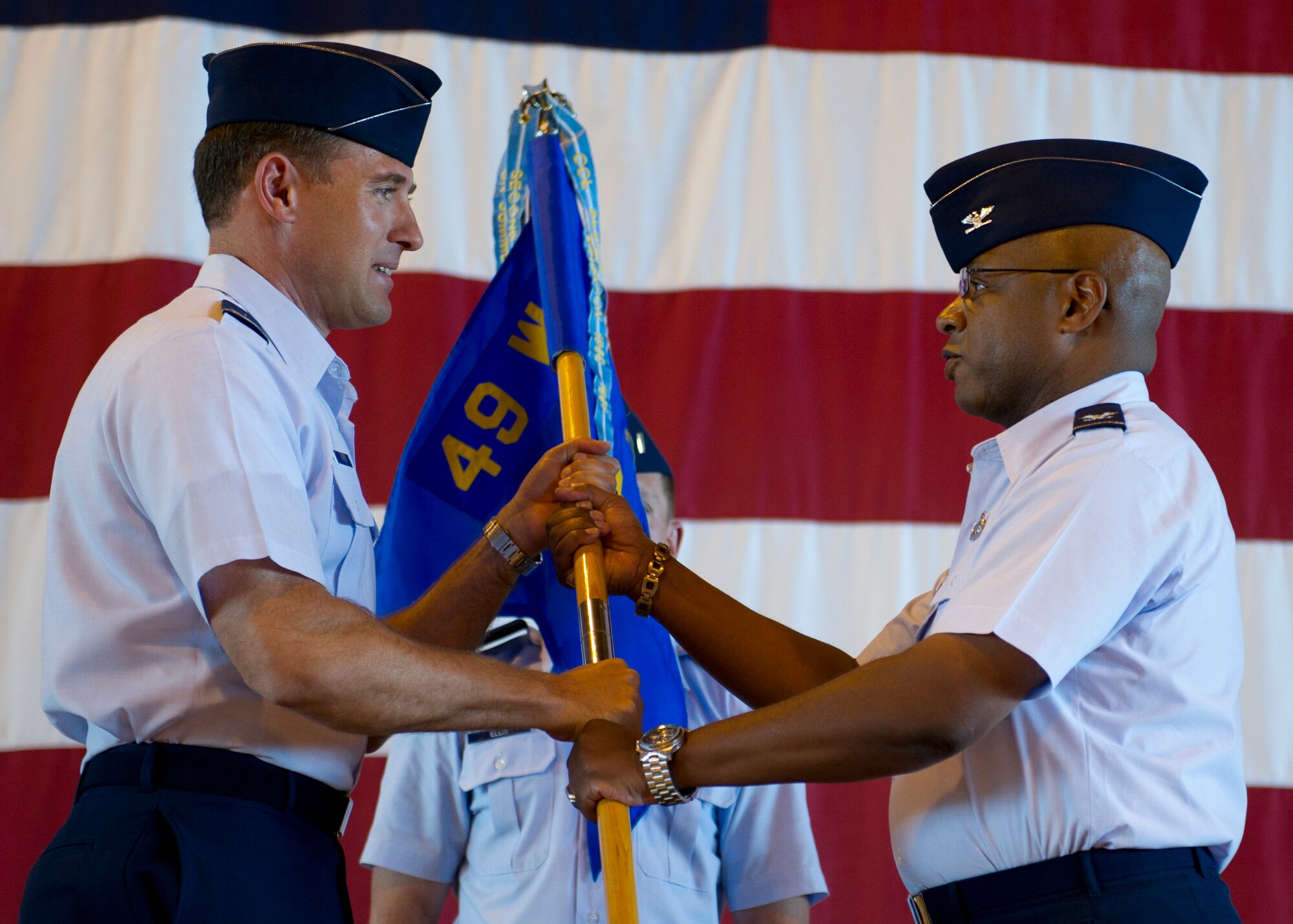 HOLLOMAN AIR FORCE BASE, N.M. -- Col. David Krumm, 49th Wing commander, bestows command of the 49th Maintenance Group to Col. André Kennedy July 11, 2011, at the 49th MXG Change of Command ceremony in Hangar 301. (U.S. Air Force photo by Senior Airman John D. Strong II/Released)