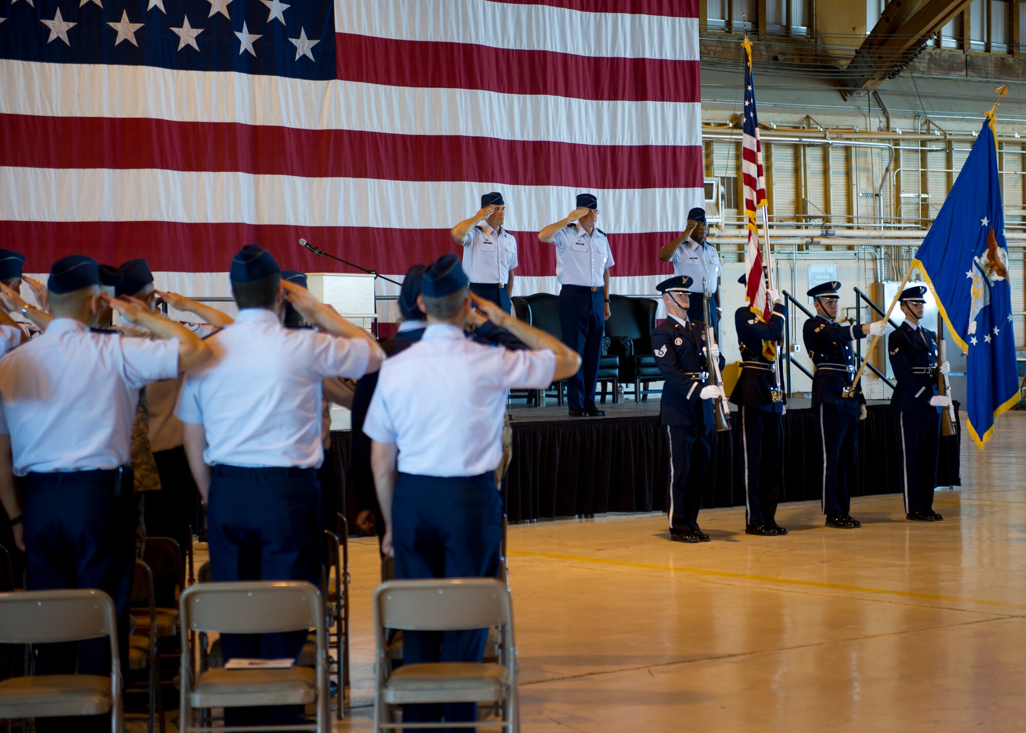 HOLLOMAN AIR FORCE BASE, N.M. -- Col. David Krumm, 49th Wing commander, Col. Donald Van Patten, former 49th Maintenance Group commander, and Col. André Kennedy, 49th MXG commander, salute during the playing of the national anthem during the 49th MXG Change of Command July 11, 2011, in Hangar 301.(U.S. Air Force photo by Senior Airman John D. Strong II/Released)