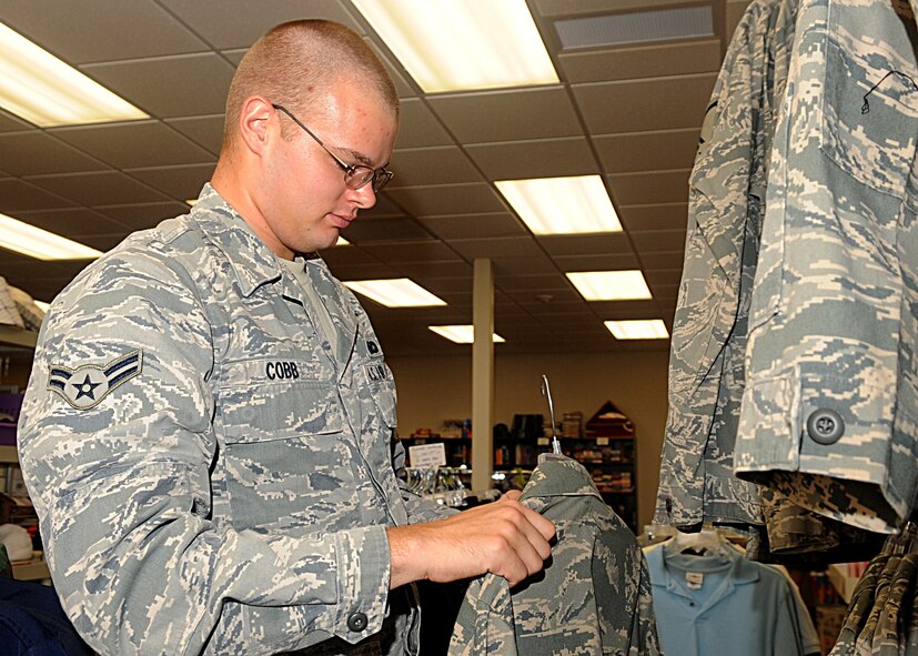 Airman 1st Class Cory Cobb, 2nd Security Forces Squadron, searches for an Airman Battle Uniform in the Airmen's Attic on Barksdale Air Force Base, La., July 14. The Airmen's Attic is a non-profit organization that receives donations of various items including clothes, household essentials, movies and uniforms. The Airmen's Attic is located at 431 Wilbur-Wright Drive and is open from 11 a.m. to 3 p.m. Tuesdays and Thursdays. For more information call 456-2400 or 456-0027. (U.S. Air Force photo/Senior Airman Kristin High)(RELEASED)