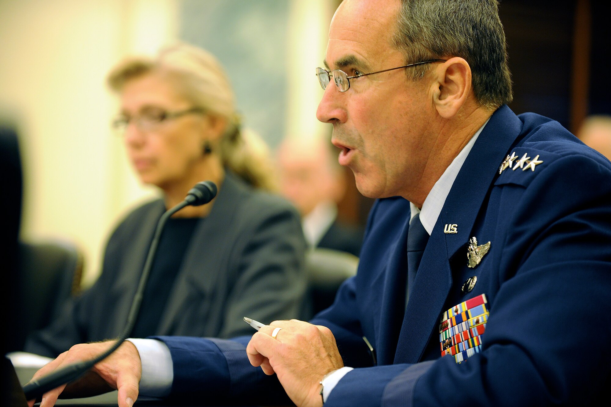 Gen. Raymond Johns, the Air Mobility Command commander, reads his opening statement July 13, 2011, during a Senate Armed Services Subcommittee on Seapower hearing on Capitol Hill in Washington, D.C. Johns testified with Christine Fox, the Department of Defense Cost Assessment and Program Evaluation director, and Gen. Duncan McNabb, the U.S. Transportation Command commander. (U.S. Air Force photo/Scott M. Ash)