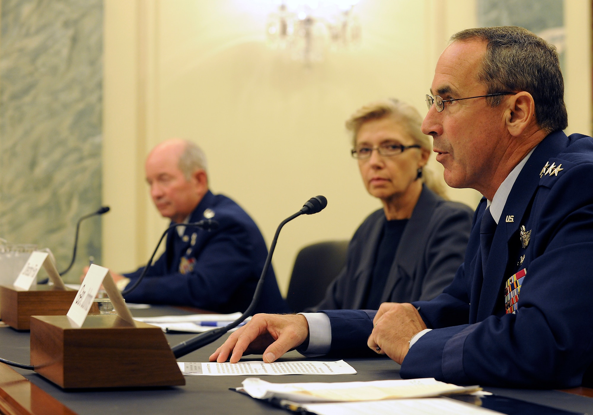 Gen. Raymond Johns, the Air Mobility Command commander, reads his opening statement July 13, 2011, during a Senate Armed Services Subcommittee on Seapower hearing on Capitol Hill in Washington, D.C. Christine Fox, the Department of Defense Cost Assessment and Program Evaluation director, and Gen. Duncan McNabb, the U.S. Transportation Command commander, also testified before the subcommittee. (U.S. Air Force photo/Scott M. Ash)