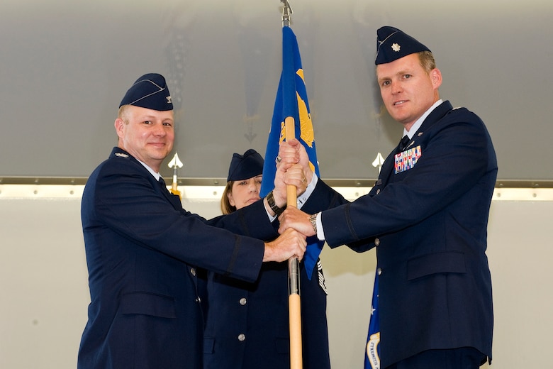 PETERSON AIR FORCE BASE, Colo.  – Colonel Chris Crawford (left), 21st Space Wing commander, passes the 21st Medical Group flag to Lt. Col. Michael Burke, who took command of the 21st Medical Group June 30. Burke will lead 400 medics to support more than 25,000 enrolled patients with facilities at Peterson Air Force Base, Schriever AFB and Cheyenne Mountain Air Force Station. Burke comes to the 21st Space Wing from Joint Base Langley-Eustis, Va., where he was the 633rd Medical Group administrator. (U.S. Air Force photo/Craig Denton)
