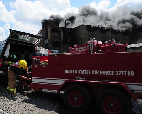 Niagara Falls Air Reserve Station Firefighters respond to a call for mutual aid support. The three-alarm fire at a warehouse in Buffalo started at approximately 5 a.m. on July 13, 2011. Lt. Kevin Mitchell (shown) and Capt. Steve Check were there to support the Buffalo Fire Department with back up foam to be used on a huge fire at a warehouse that stored oil, grease, and propane. (U.S. Air Force Reserve photo by Peter Borys) 

