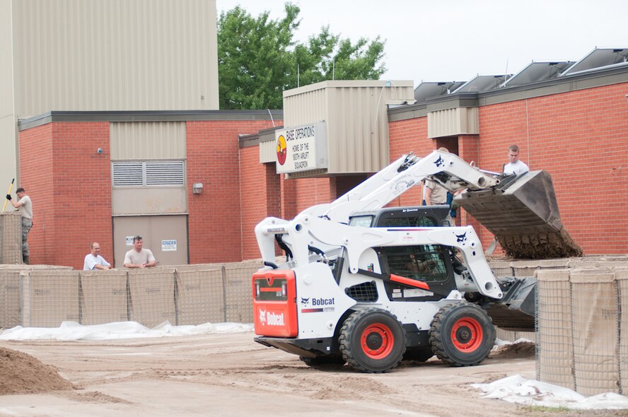 Airmen of the 139th Airlift Wing, Missouri Air National Guard build HESCO barriers around buildings on Rosecrans Air National Guard Base, St. Joseph, Mo., July 13, 2011.  These barriers are being put into place as a preparative action in case the Missouri River levees are breached.  (U.S. Air Force photo by Senior Airman Sheldon Thompson)