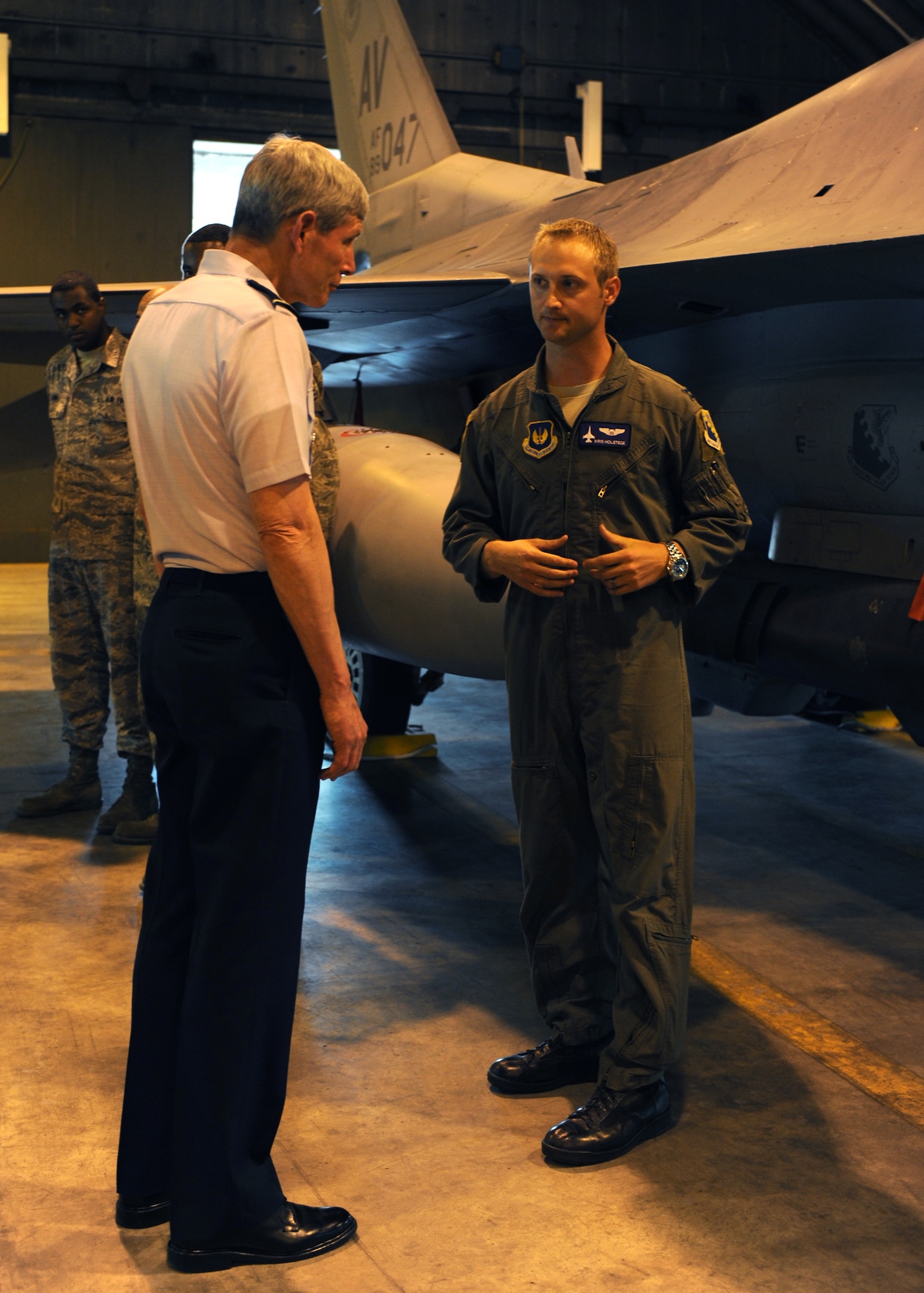 Capt. Kristopher Holstege talks with Air Force Chief of Staff Gen. Norton Schwartz on July 11, 2011, at Aviano Air Base, Italy. The general and his wife Suzie were visiting Aviano to meet with Airmen and their families and observe the installation’s mission.  Holstege is the 510th Fighter Squadron chief of plans.  (U.S. Air Force photo/Staff Sgt. Nadine Y. Barclay)