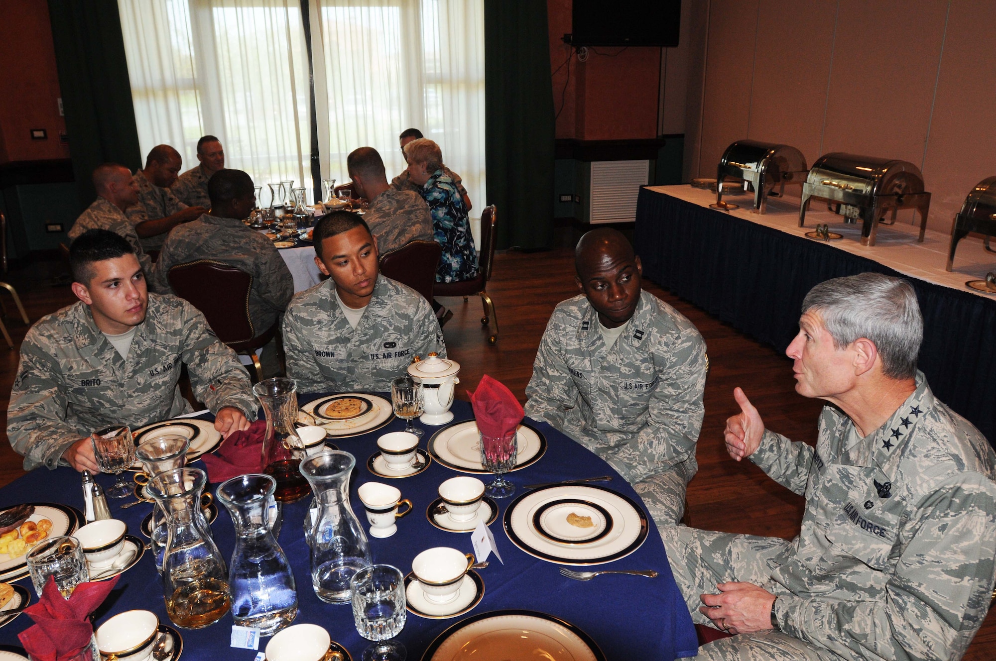 Air Force Chief of Staff Gen. Norton Schwartz chats with Airmen July 12, 2011, at La Bella Vista Club at Aviano Air Base, Italy. The general and his wife Suzie were visiting Aviano to meet with Airmen and their families and observe the installation’s mission.  Schwartz shared lunch with Aviano personnel during which he discussed issues affecting Airmen. (U.S. Air Force photo/Airman LaVel D. Sterling)