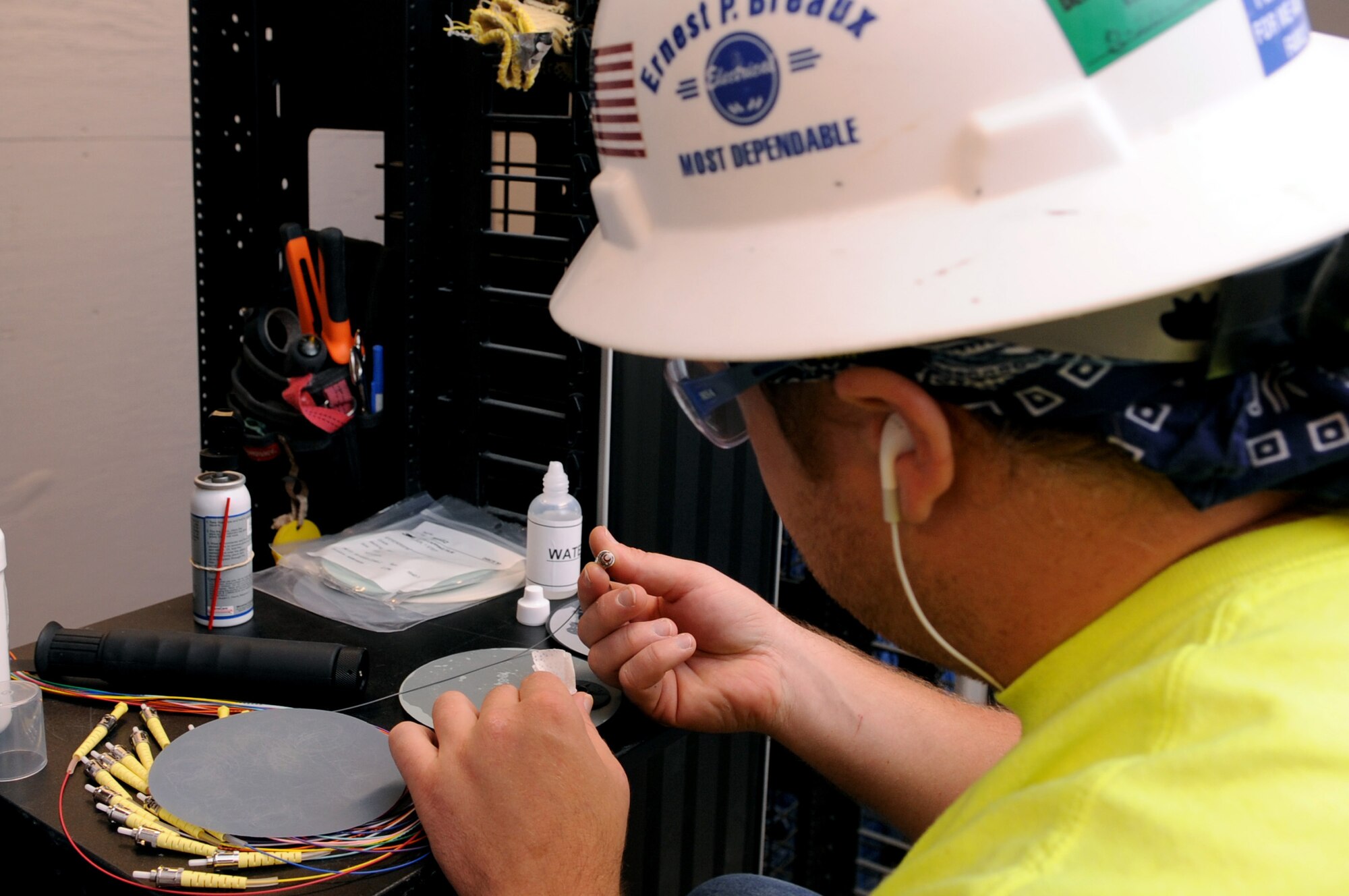 Chris Hayes, a contracted communication technician, polishes fiber-optic connectors in a newly renovated building on Barksdale Air Force Base, La., July 13. The fiber-optic cable is used for network connectivity. (U.S. Air Force photo/Senior Airman La'Shanette V. Garrett)(RELEASED)