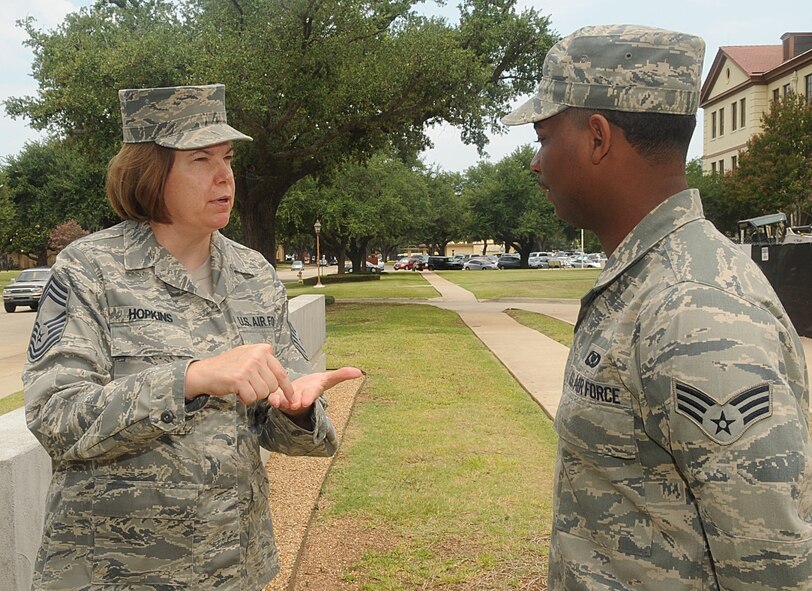 Chief Master Sgt. Laura Hopkins mentors Senior Airman Corvecco Pugh, both of Air Force Global Strike Command, on Barksdale Air Force Base, La., July 14. On a daily basis Hopkins mentors numerous Airmen throughout the base. (U.S. Air Force photo/Senior Airman Kristin High)(RELEASED)