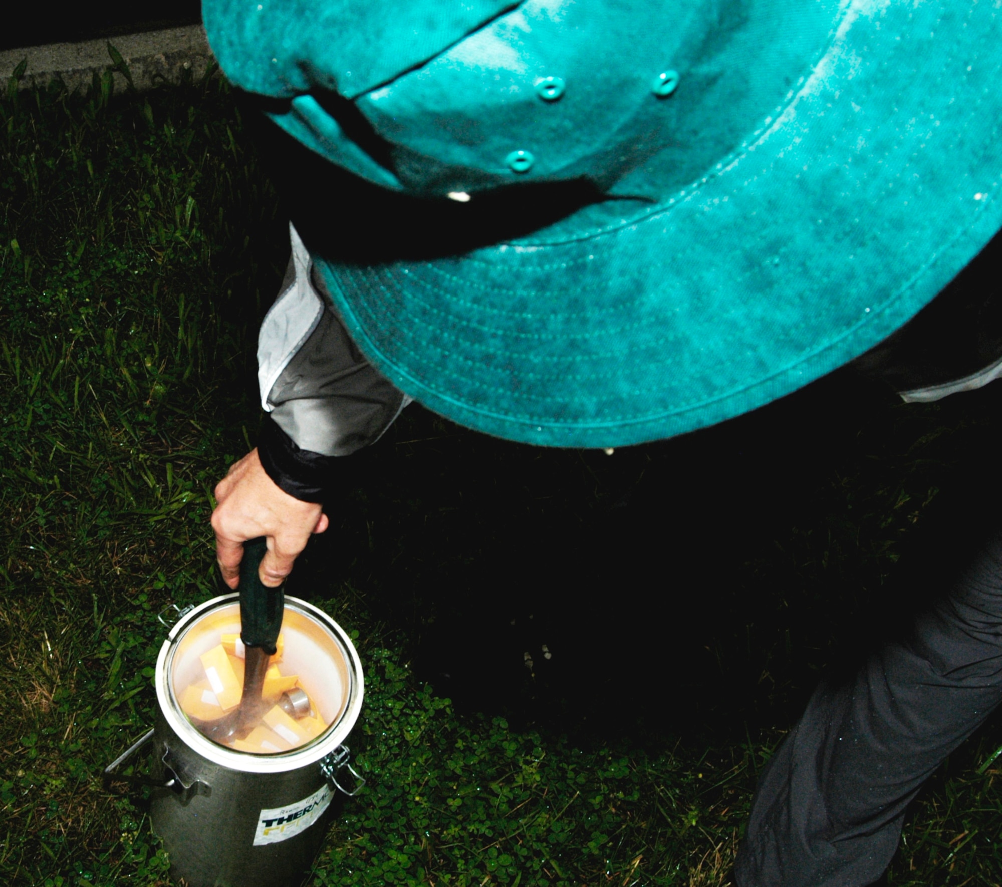Professor Pierluigi (Enrico) Bonello from The Ohio State University Department of Plant Pathology pushes down tree samples in a thermos with liquid nitrogen to transport the samples back to the lab for testing. (U.S. Air Force photo by Ted Theopolos)