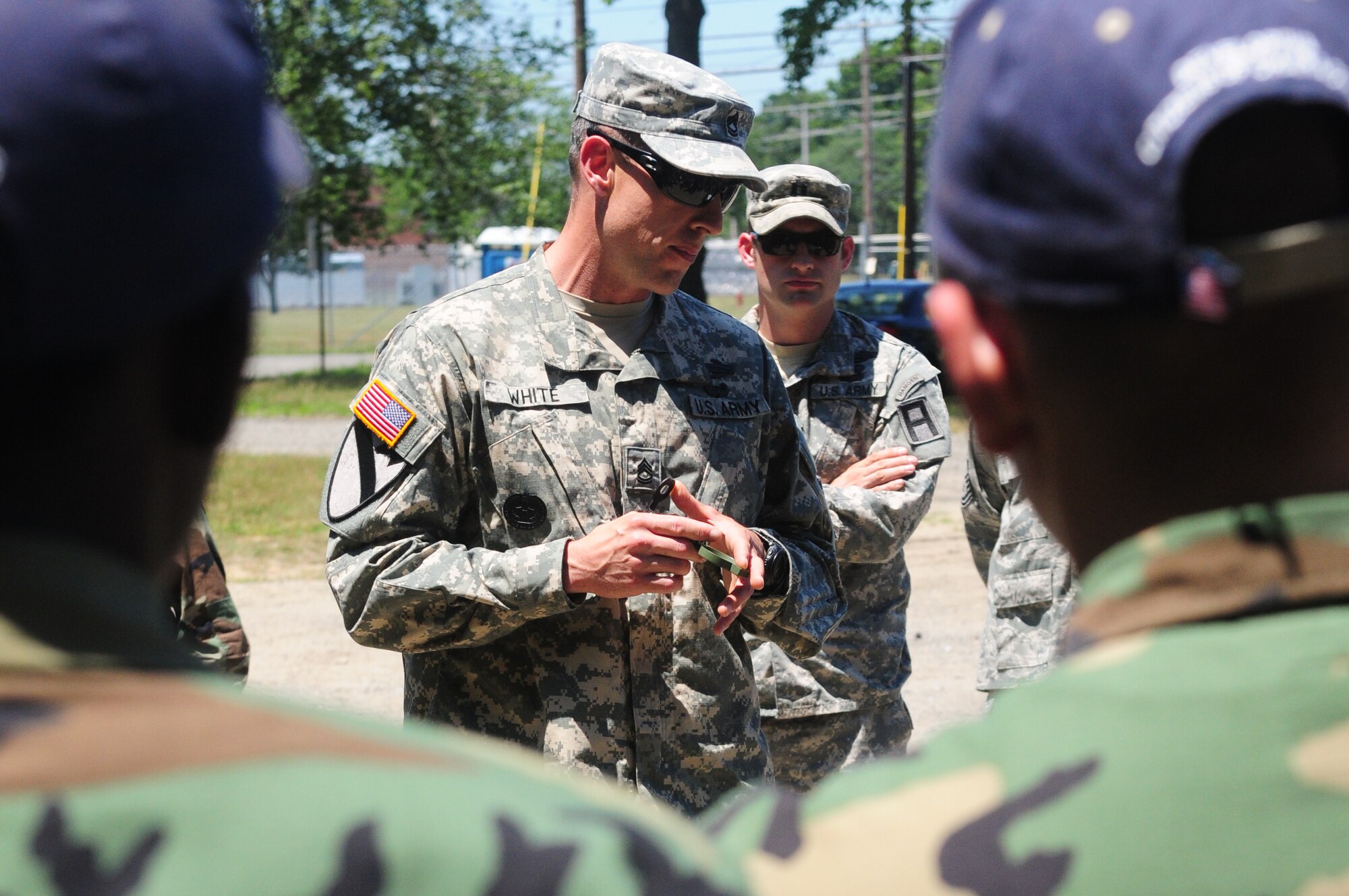 Sgt. 1st Class Daniel White, 1st Battalion, 307th Training Support Battalion, gives U.S. Air Force Junior Reserve Officers’ Training Corps cadets a compass familiarization class to successfully traverse the land navigation course June 29 at Joint Base McGuire-Dix-Lakehurst. The cadets, representing high schools from New Jersey, Pennsylvania and New York gathered at JB MDL to traverse the same land navigation course servicemembers use training for deployment in support of ongoing contingency operations. (U.S. Army photo by Spc. Darryl L. Montgomery/Released)