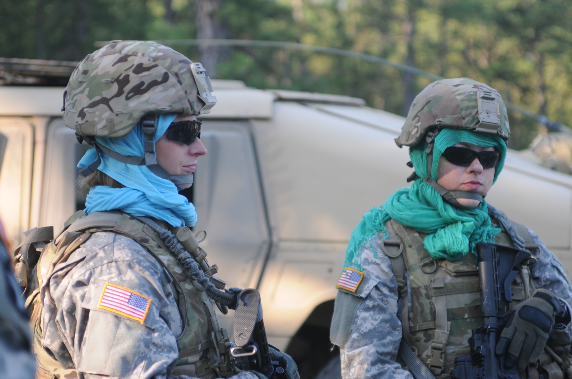 Staff Sgt. Kailah M. Karl and Spc. Nataly L. Clapp prepare for Female Engagement Team training at Joint Base McGuire-Dix-Lakehurst June 28. Wearing scarves known as hijabs underneath their Army Combat Helmets, the Soldiers received instructions for their mission. This training encourages FETs to acknowledge local customs and courtesies while establishing relationships among Afghani women. (U.S. Army photo by Army Spc. Amanda M. Hils/Released)