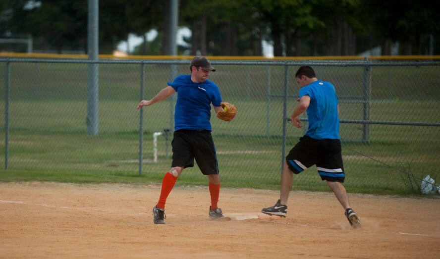Jason Sebring, 23rd Force Support Squadron, attempts to make the play at first after a bad throw during a tournament game at Moody Air Force Base, Ga., July 13, 2011. The 23rd Wing still managed to get the win over the 23rd Civil Engineer Squadron with a score of 13-3. (U.S. Air Force photo by Airman 1st Class Joshua Green/Released)

