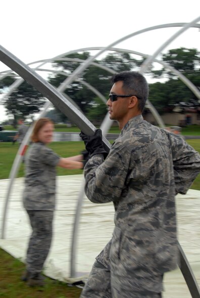 Lt. Col. Simon Nguyen, of the 178th Medical Group, Springfield, Ohio, sets up tent framework during Expeditionary Medical Support Basic refresher training July 12 as part of Patriot Exercise 2011 at Volk Field Combat Readiness Training Center, Wis.  EMEDS Basic is designed to facilitate surgical and primary medical care in a deployed environment. (U.S. Air Force photo by Senior Airman Amy N. Adducchio/Released)