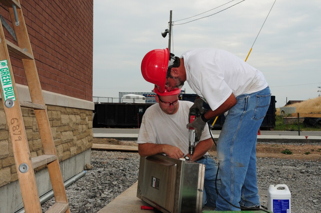Construction workers are busy getting the Community Activities Center (CAC) ready for completion at the Niagara Falls Air Reserve Station, N.Y. on July 11, 2011.  The CAC will replace the old 1950s era dining hall with a new, bigger modern facility.  The 18,000 square foot, $10.3 million project is slated to open in mid August. (U.S. Air Force Reserve Photo by Peter Borys)