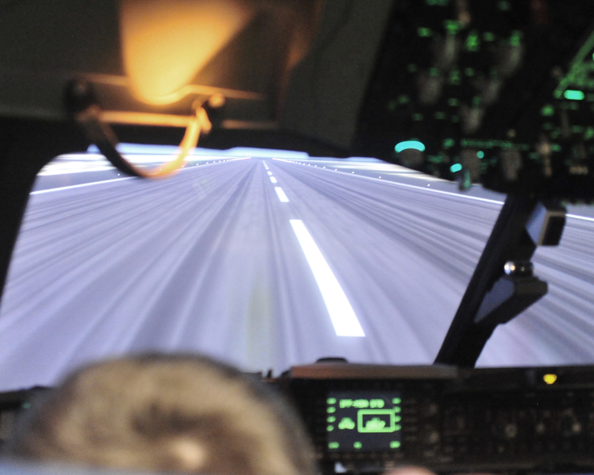 Evan Waara, "Pilot for a Day," attempts to "land" while on a C-17 aircraft simulator July 7 at Joint Base Lewis-McChord, Wash. The simulator was only one of several events during Evan's participation in the Pilot for a Day program. (Air Force photo/Staff Sgt. Frances Kriss)